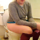 A girl takes a piss and a shit while sitting on a toilet, then wipes herself. She does not show her entire face, nor does she show the poop. Audible pissing and plop sounds. Over 2 minutes.